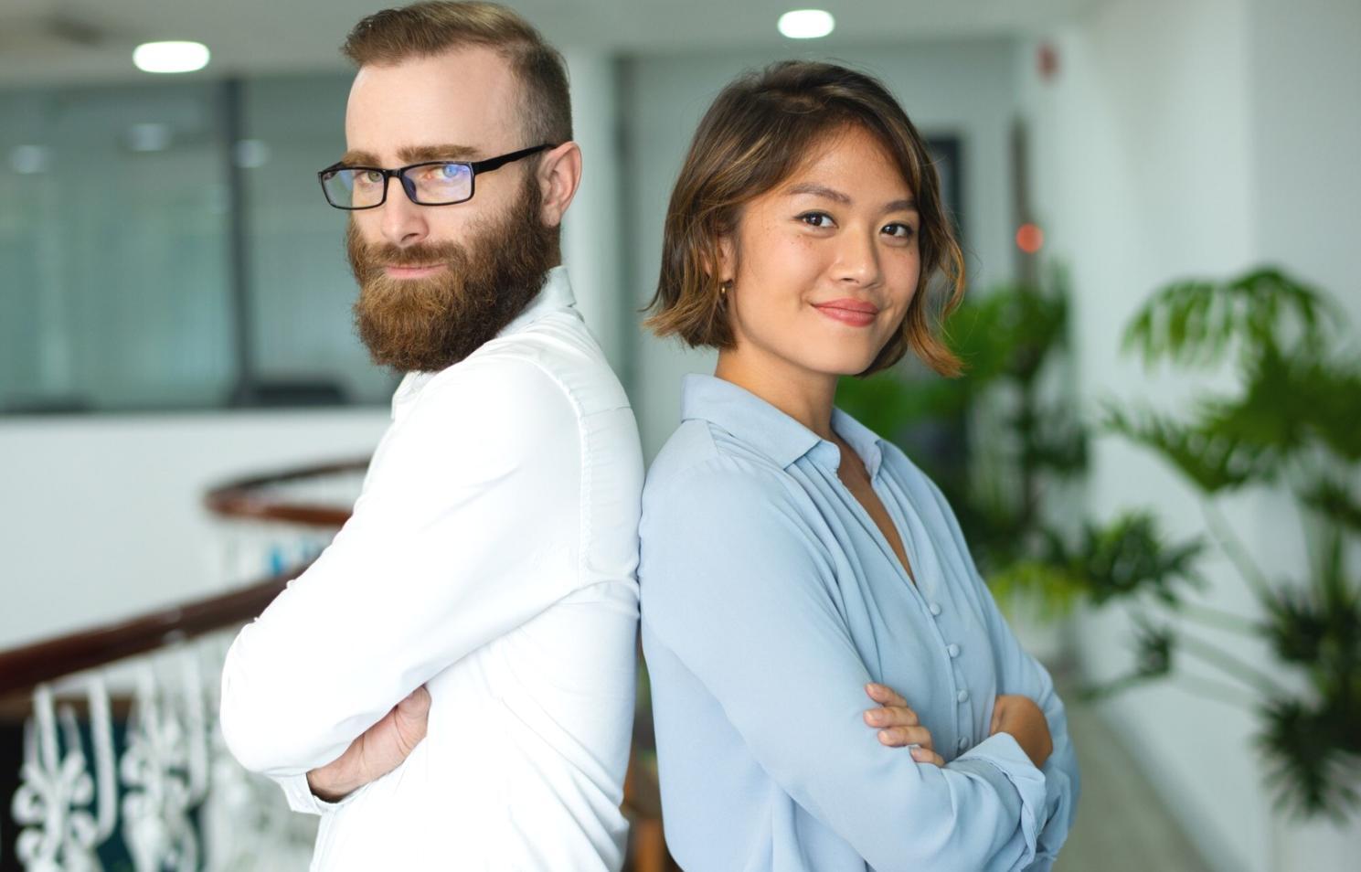 Students collaborating on financial analysis project with laptops and documents